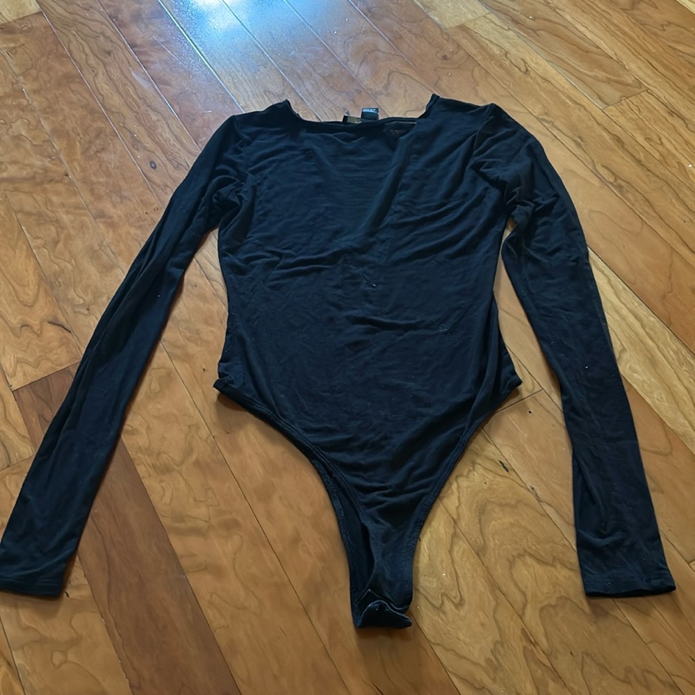 black going out body suit with a sheer deep vee